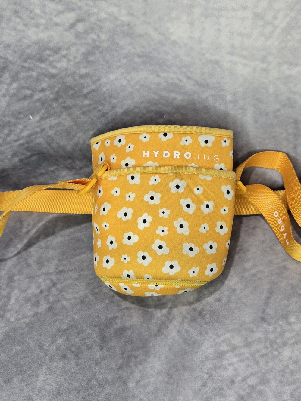 HydroJug water bottle sleeve featuring a white and black daisy or poppy pattern